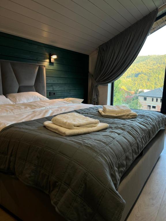 a bedroom with a bed with towels on it at Guest house Zatishniy dvir in Yaremche