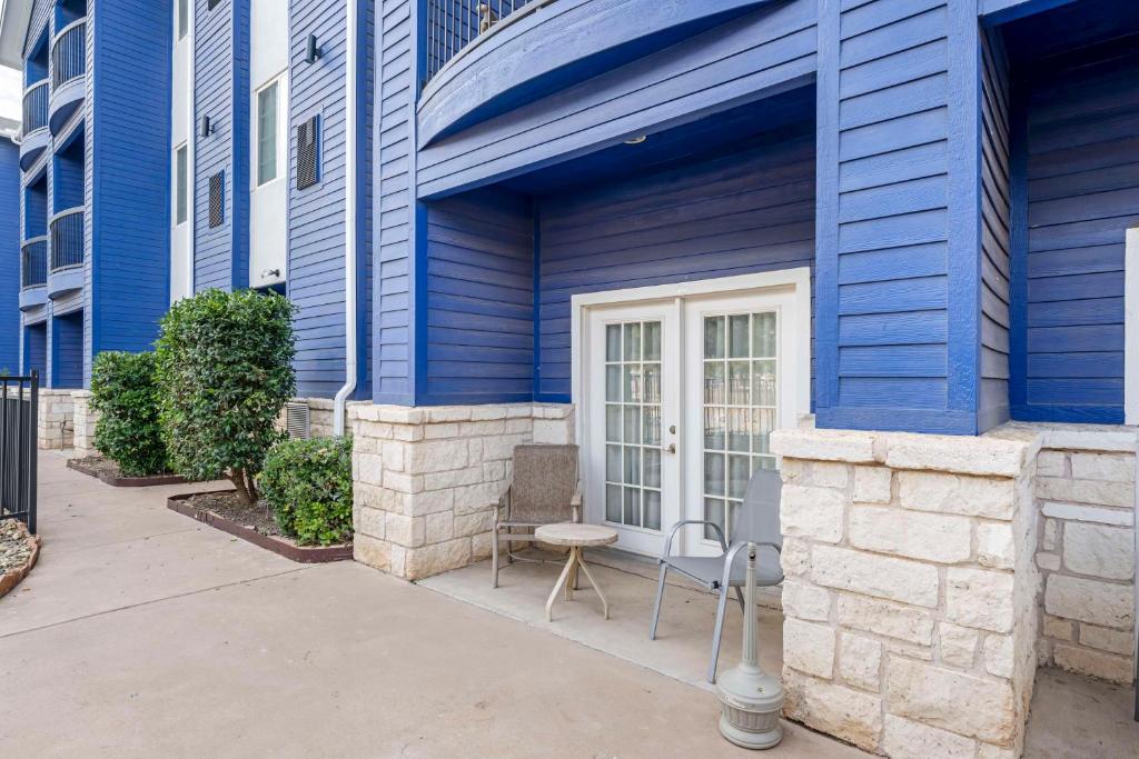 a blue house with a chair on a sidewalk at Best Western Lubbock West Inn & Suites in Lubbock
