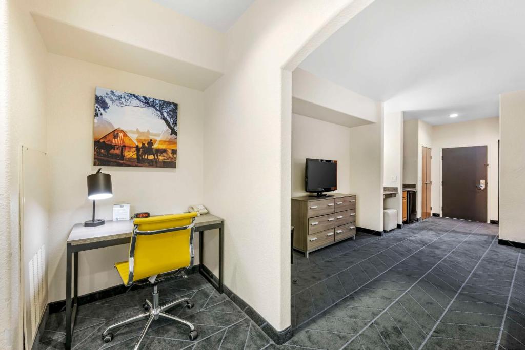 a hotel room with a desk and a tv at Best Western Lubbock West Inn & Suites in Lubbock