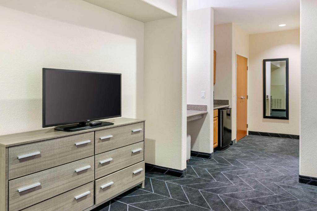 a hotel room with a flat screen tv on a dresser at Best Western Lubbock West Inn & Suites in Lubbock