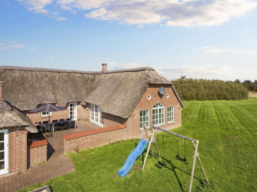 een luchtzicht op een huis met een speeltuin bij 4 star holiday home in Ulfborg in Ulfborg