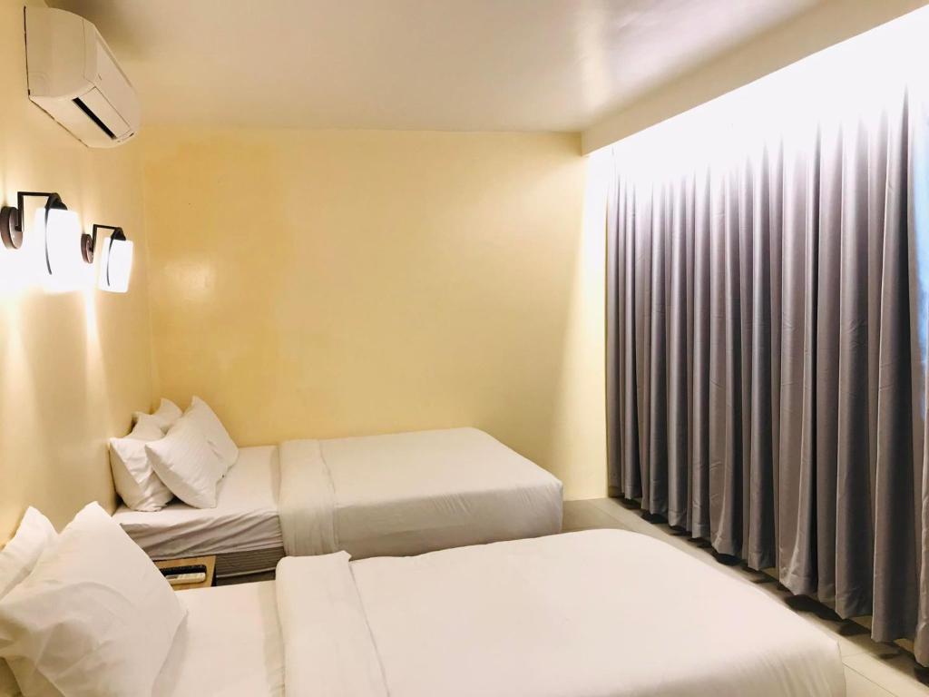 Postel nebo postele na pokoji v ubytování Dosi Hotel PH