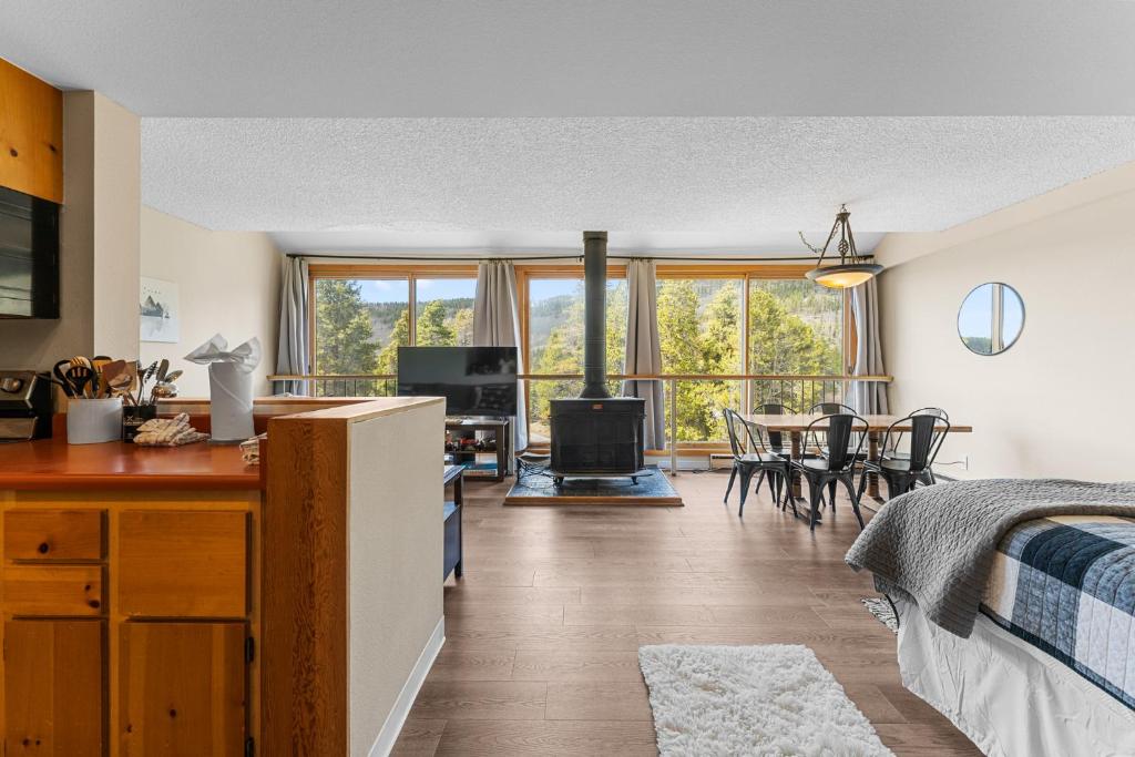 a bedroom with a bed and a dining room with a table at Decatur 1797 by Summit County Mountain Retreats in Keystone