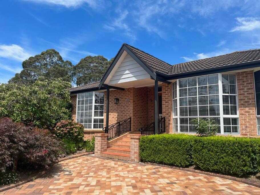 a brick house with a brick driveway at The Cricket House - Family & Pet-Friendly Home in Bowral