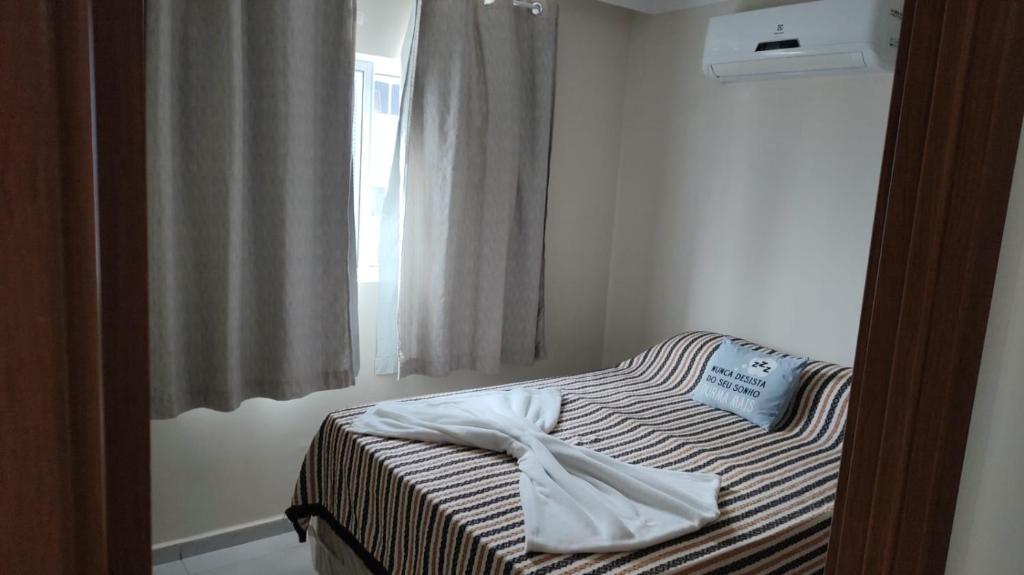 a bed in a room with a window at Espaço ling in João Pessoa