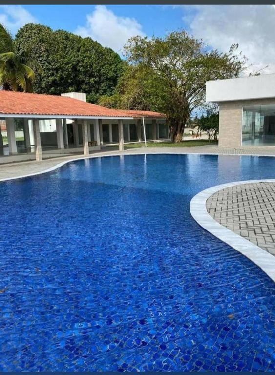 a pool with blue water in front of a building at Espaço ling in João Pessoa