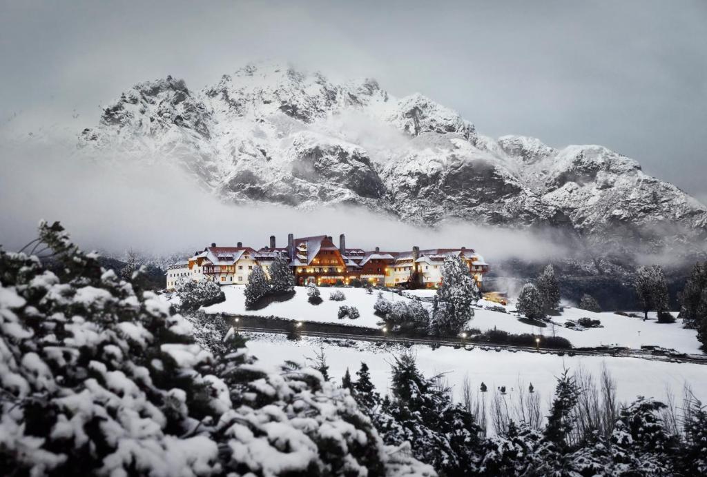 a resort in front of a snow covered mountain at Llao Llao Resort, Golf-Spa in San Carlos de Bariloche
