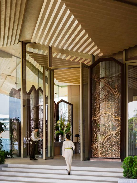 a rendering of a building with a woman walking down a hallway at Dusit Thani Bangkok in Bangkok