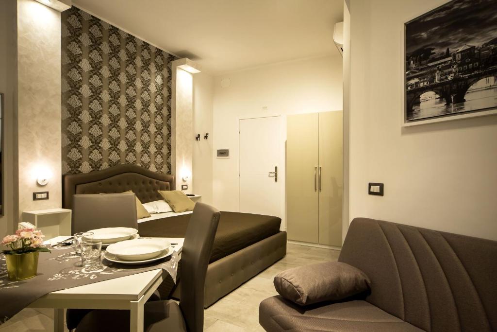 a living room with a couch and a dining room at Inn Rhome S Pietro Suites in Rome