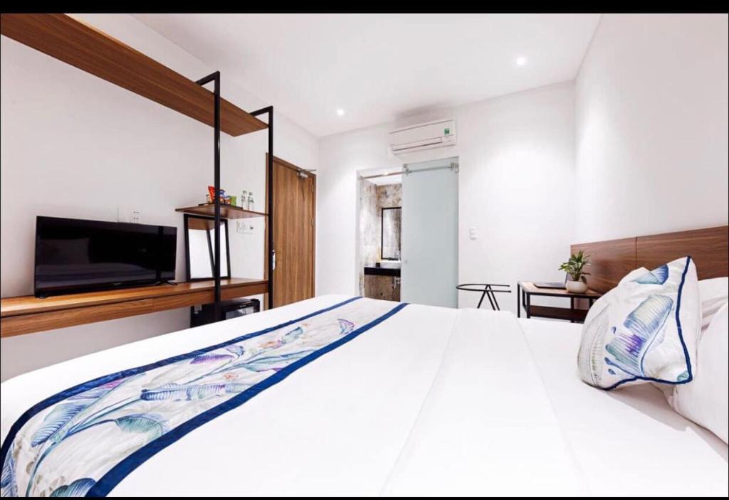 Postel nebo postele na pokoji v ubytování Essenza Hotel Đà Nẵng