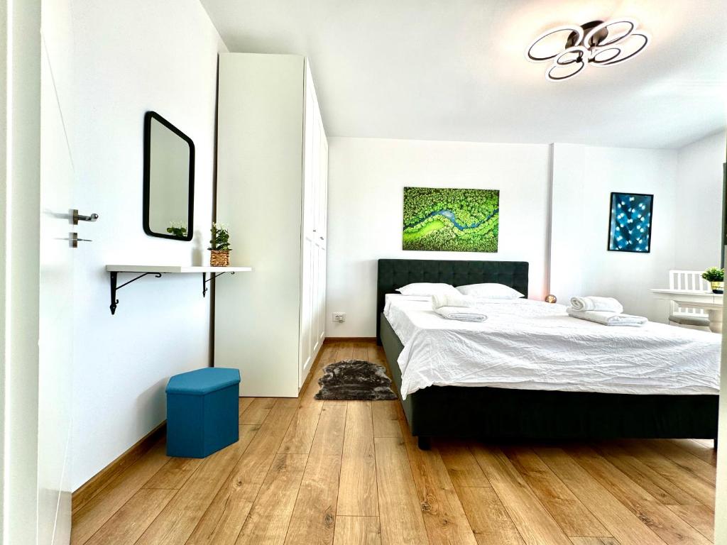 a bedroom with a bed and a mirror at Park View Studio in Timişoara