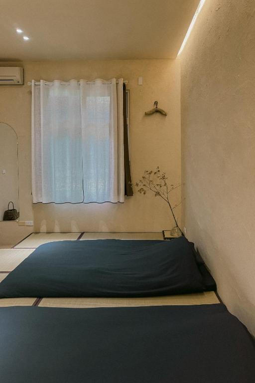Postel nebo postele na pokoji v ubytování Dew&Plum 白露梅室