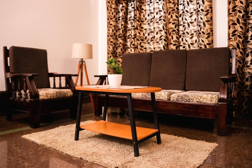 a living room with a couch and a table at Akim Homestay in Kohīma