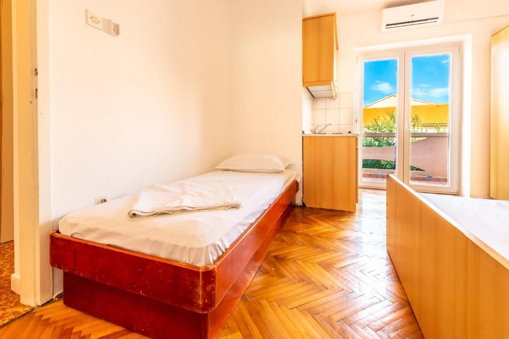 Łóżko lub łóżka w pokoju w obiekcie Apartments Matulo