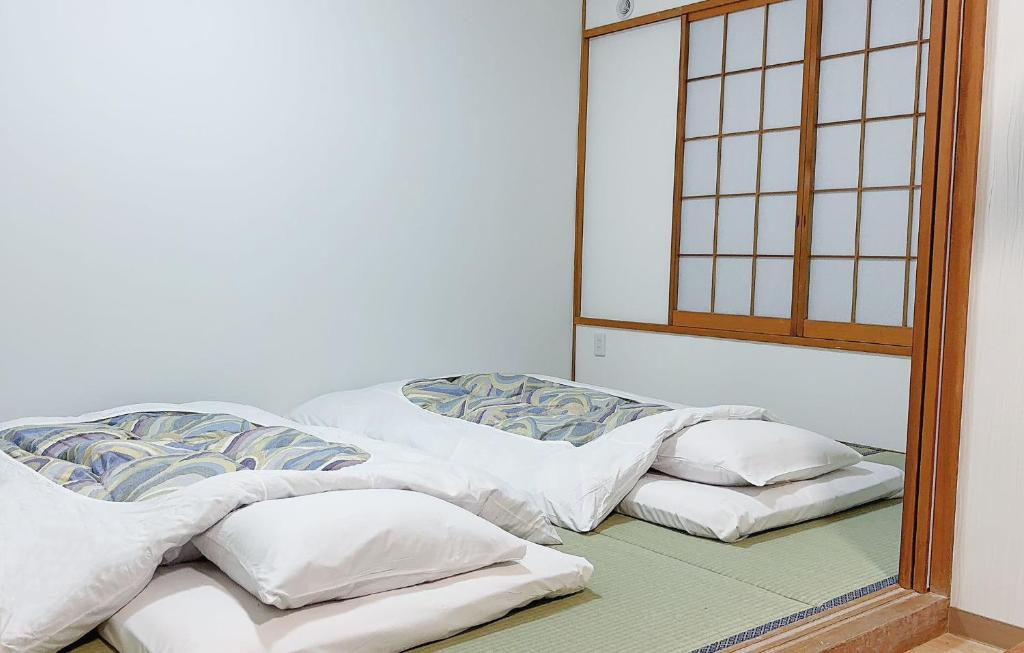 Postel nebo postele na pokoji v ubytování 軽井沢七福荘ホテル