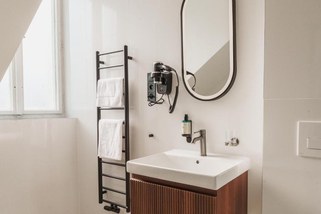 a bathroom with a sink and a mirror at Esplanade Carlsbad in Karlovy Vary
