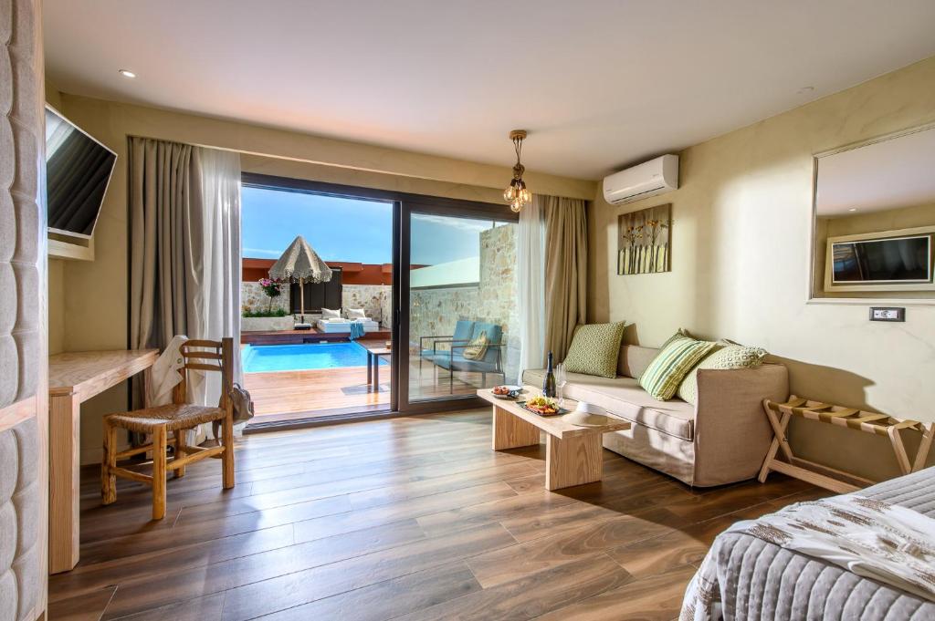 a living room with a couch and a table at Esperides Resort Crete, The Authentic Experience in Hersonissos