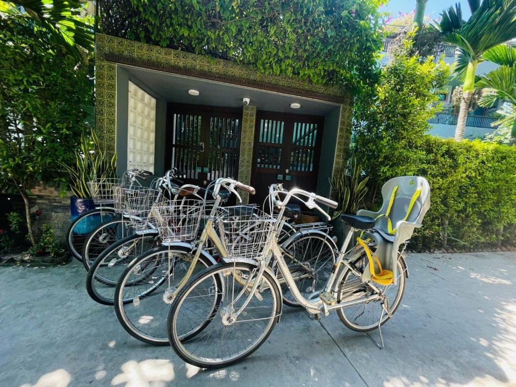 a group of bikes parked in front of a building at CHiEM HoiAn - The Beachside Boutique Hotel & Villa in Hoi An
