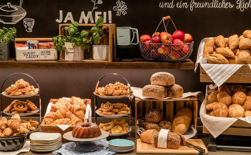a bakery with different types of bread and pastries at Motel One Hamburg Airport in Hamburg