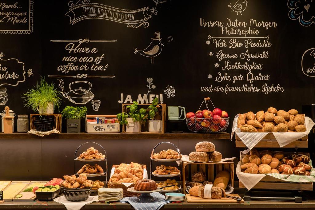 a bakery with different types of bread and pastries at Motel One Hamburg Airport in Hamburg