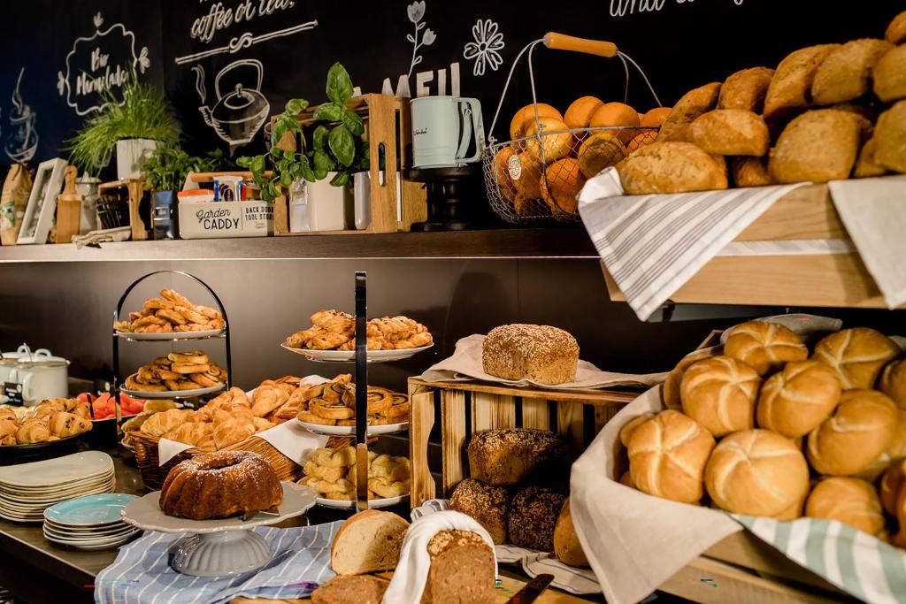 a bakery with lots of bread and pastries on display at Motel One Hamburg Airport in Hamburg