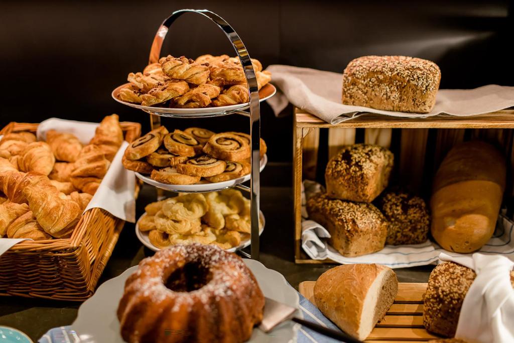 a display of different types of bread and pastries at Motel One Hamburg Airport in Hamburg