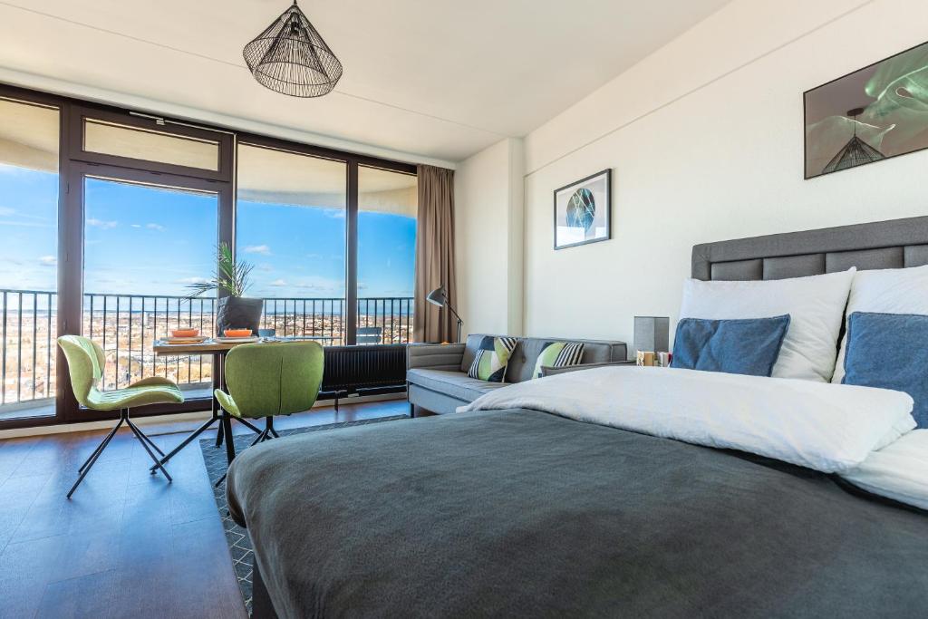 a bedroom with a large bed and a balcony at Fantastic Views Augsburg Center Luxury Congress in Augsburg