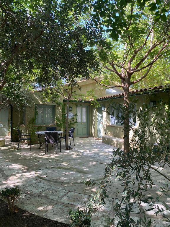 a patio with a table and a bench in front of a house at Casa Valley Boutique in Melegis