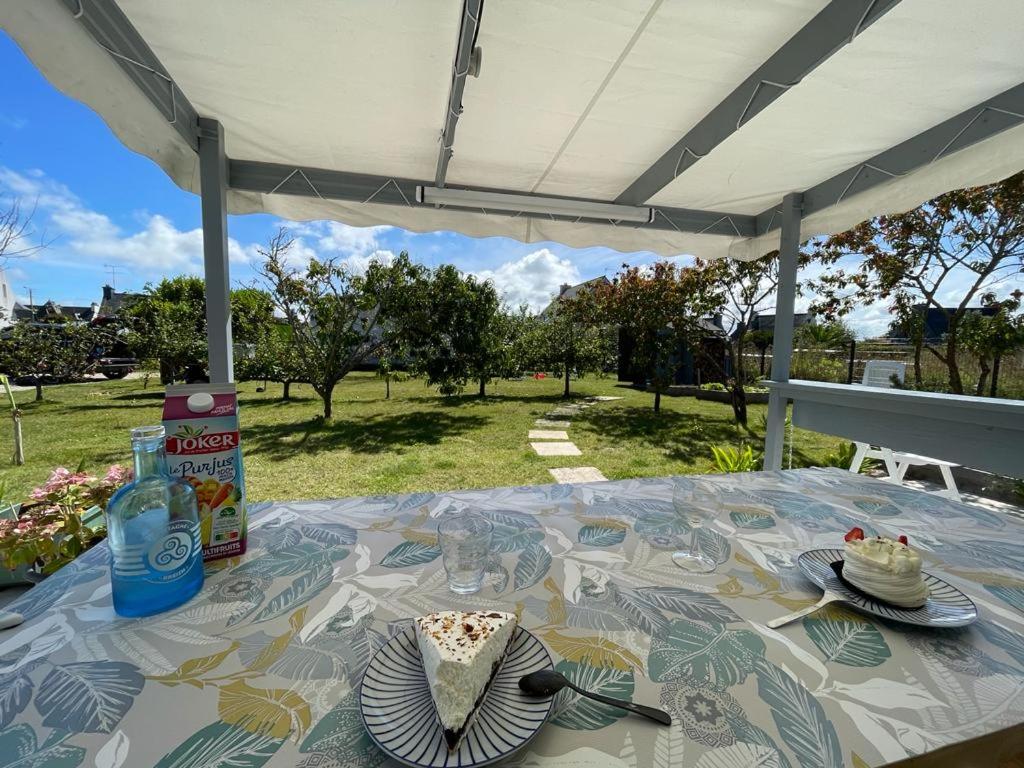 a table with plates on it under a tent at TI KAZ - Terrasse extérieure - 5mn Plage in Pleubian