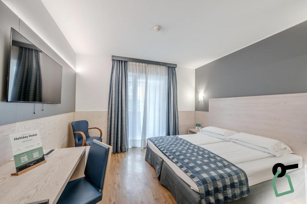 Postel nebo postele na pokoji v ubytování HOTIDAY Room Collection - Torbole