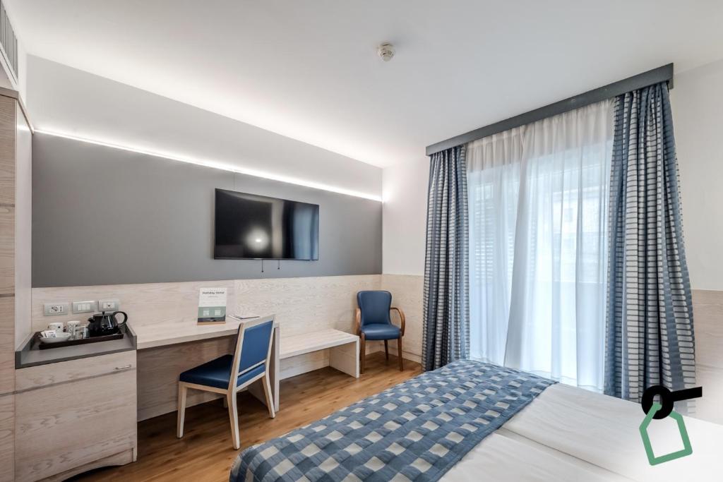 Postel nebo postele na pokoji v ubytování HOTIDAY Room Collection - Torbole