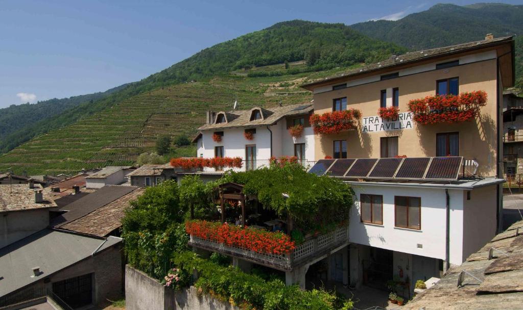 a group of buildings with flowers on the roofs at Altavilla Locanda E Tipica Trattoria in Bianzone