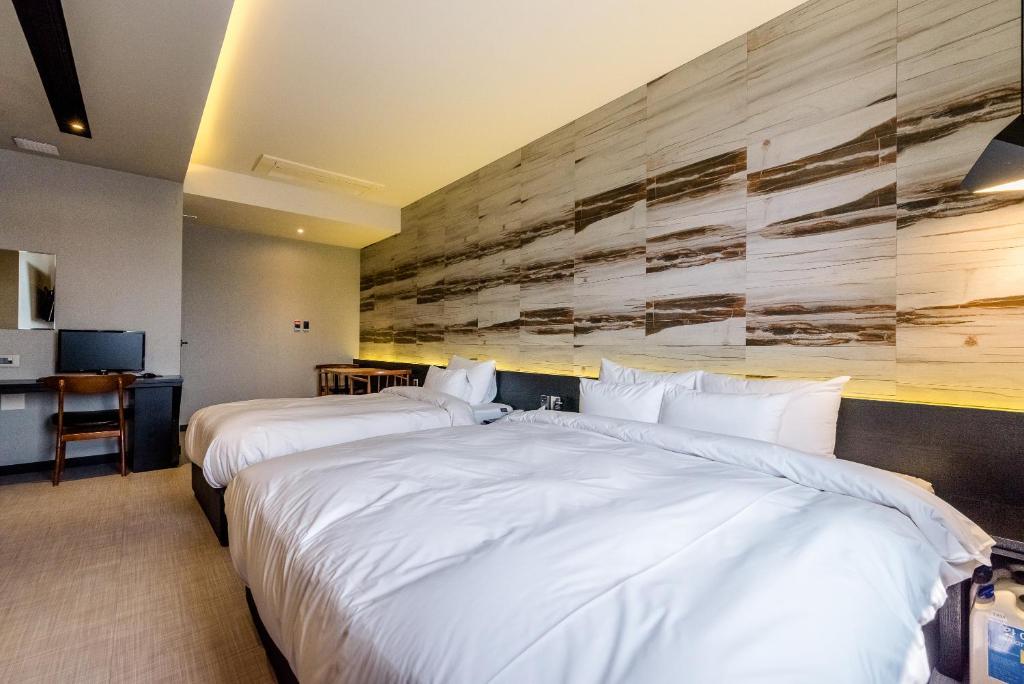 Postel nebo postele na pokoji v ubytování Hotel Marcher