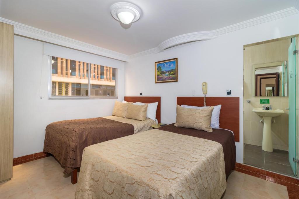 Postel nebo postele na pokoji v ubytování Hotel Zulita