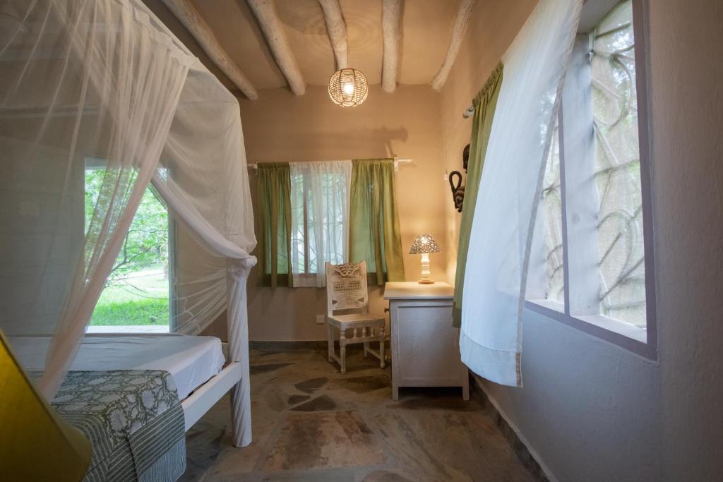 Postel nebo postele na pokoji v ubytování Villa Nyumba Hatimaye