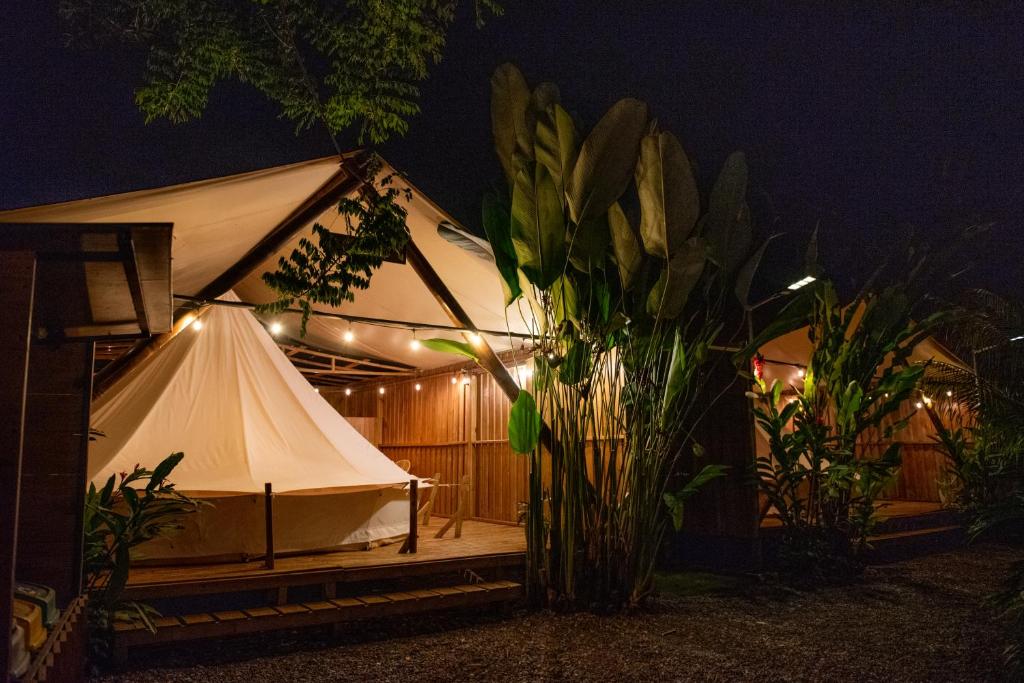 a white tent with lights on it at night at Seren Glamping in Uvita