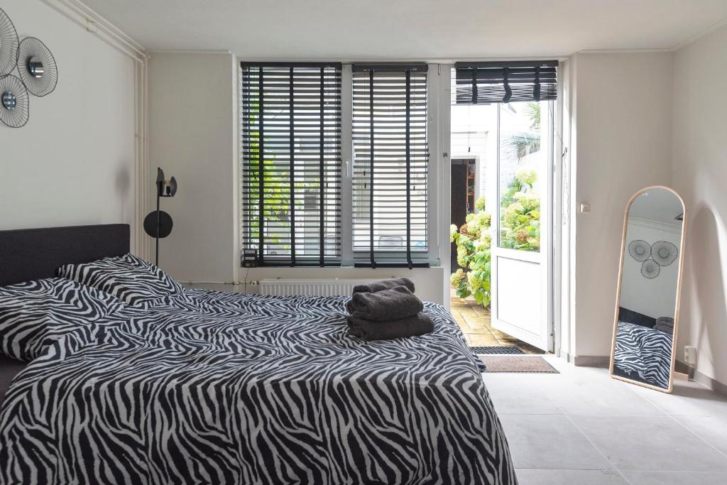 a bedroom with two beds and a surfboard in it at Zaras Studio Hermes in Zandvoort