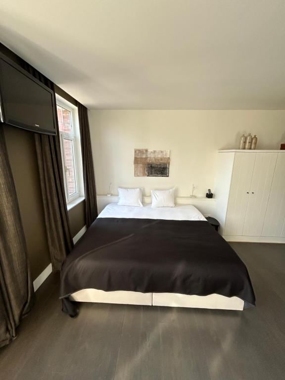 Postel nebo postele na pokoji v ubytování Boutique hotel Roosendaelhof