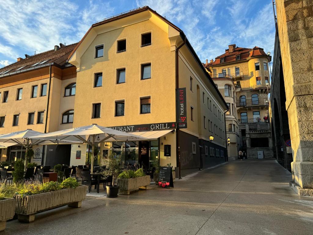 an empty street in a city with buildings at Hotel Lent in Maribor