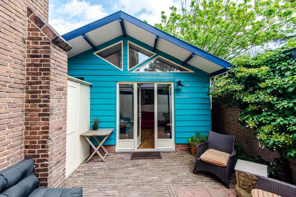 a blue house with a patio in front of it at Ocho in Zandvoort