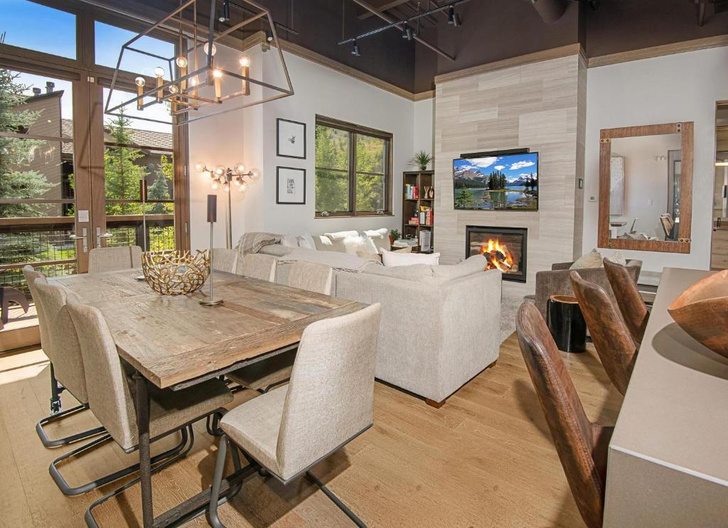 a living room with a dining table and a fireplace at Brookside Townhome #107 in Avon
