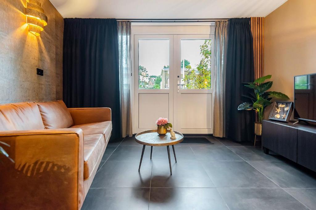 a living room with a couch and a table at Loft 29 in Zandvoort