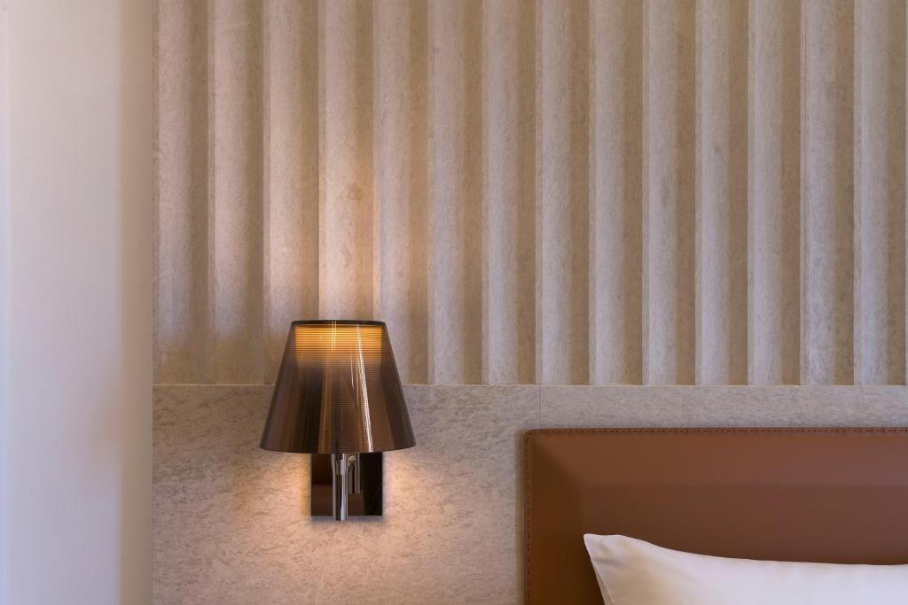 Postel nebo postele na pokoji v ubytování Maniace Boutique Hotel Ortigia | UNA Esperienze