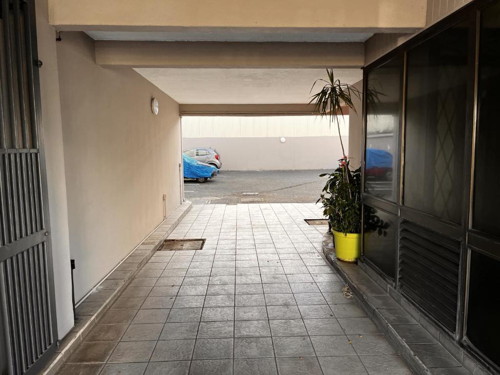 a hallway of a parking lot with a potted plant at NEW My Lodge - Parking, AC, Netflix & Wifi in Papeete