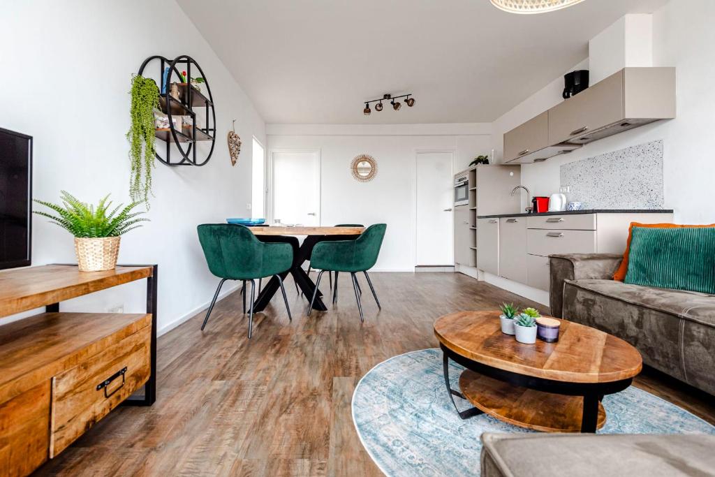 a living room with a couch and a table at De Schelp 85 in Zandvoort