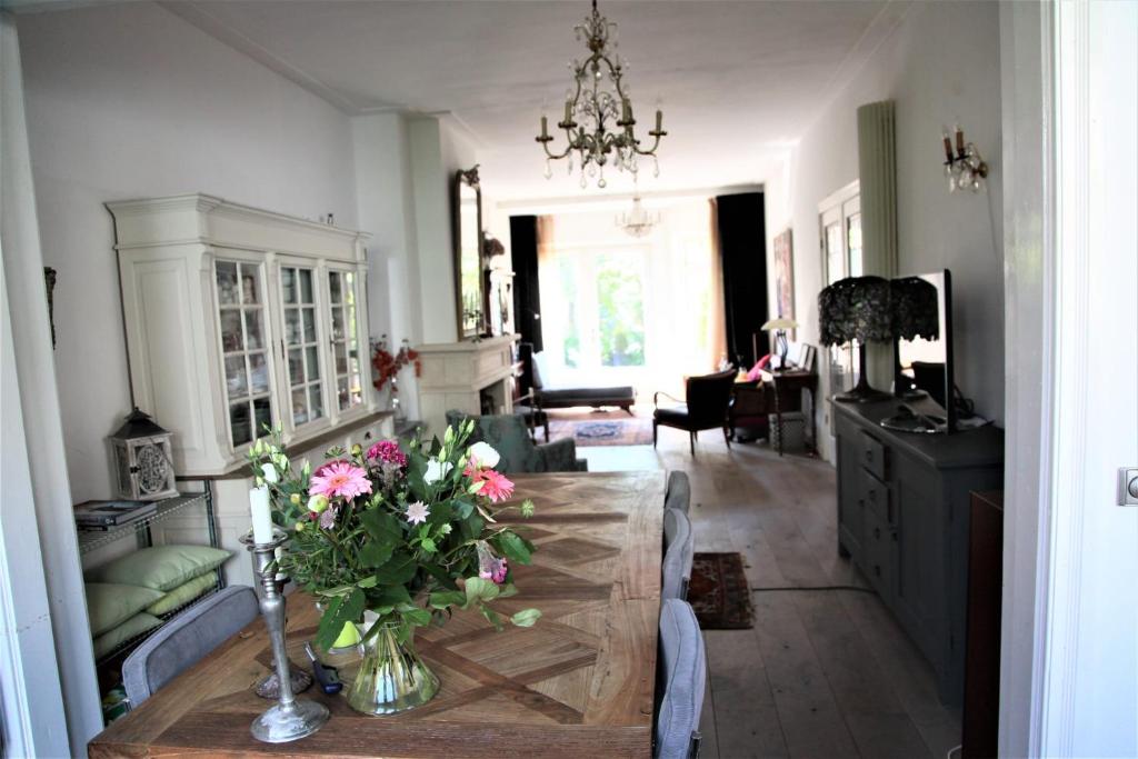 a living room with a table with flowers on it at Family Home Marie in Zandvoort