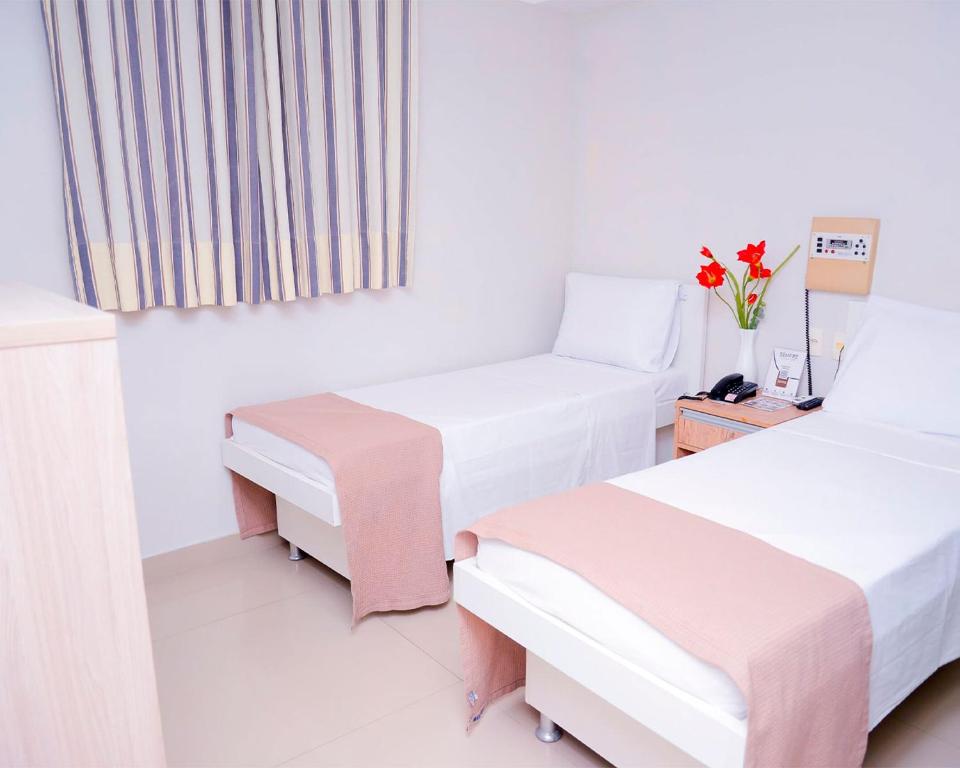 Postel nebo postele na pokoji v ubytování Hotel Sempre Bahia