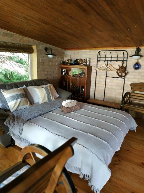 a bedroom with a large bed in a room at 100SaulesVikingi in Grobiņa