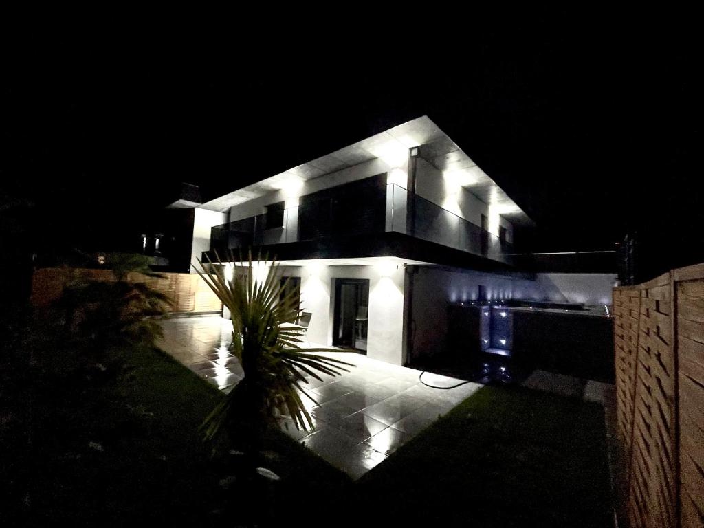a house lit up at night with lights at Maison Jacuzzi in Thonon-les-Bains
