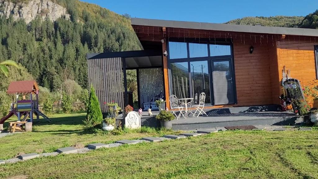 a house with a view of a mountain at Casuta de sub stanca Apuseni,hot tub inclus in Bîrdeşti